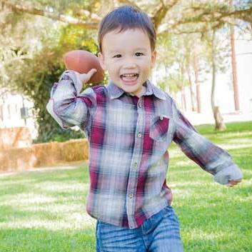 Young boy throwing ball